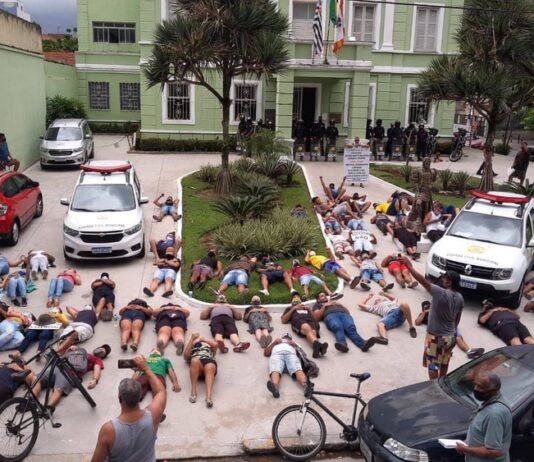 Manifestantes deitam no chão em frente à prefeitura de São Vicente para protestar contra lockdown